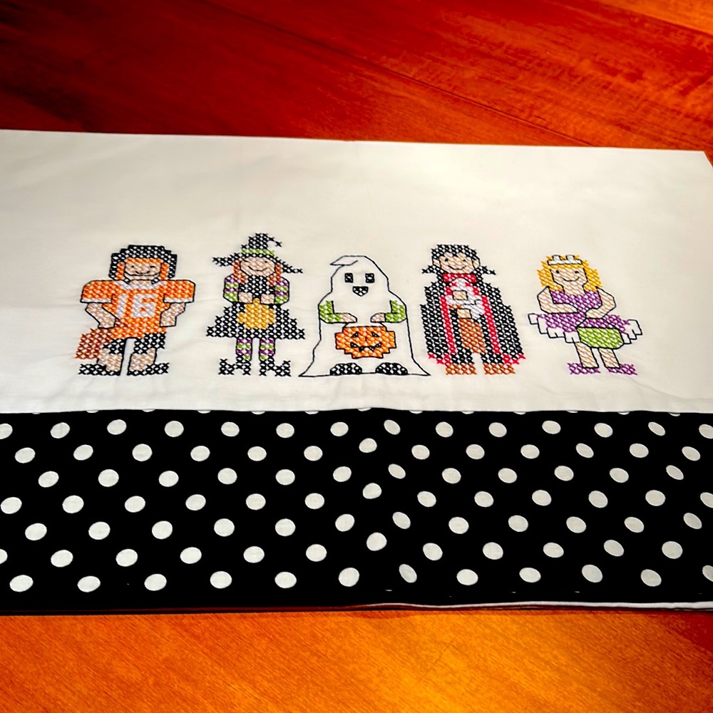 One standard size pillowcase with trick or treat kids cross stitched on it